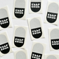 Black and white pill-shaped stickers that state KEEP GOING